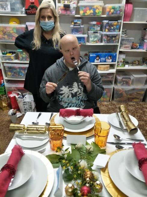 Independent Living Skills with Reach & Belong NDIS participant learning how to set a table for special occasions like Christmas