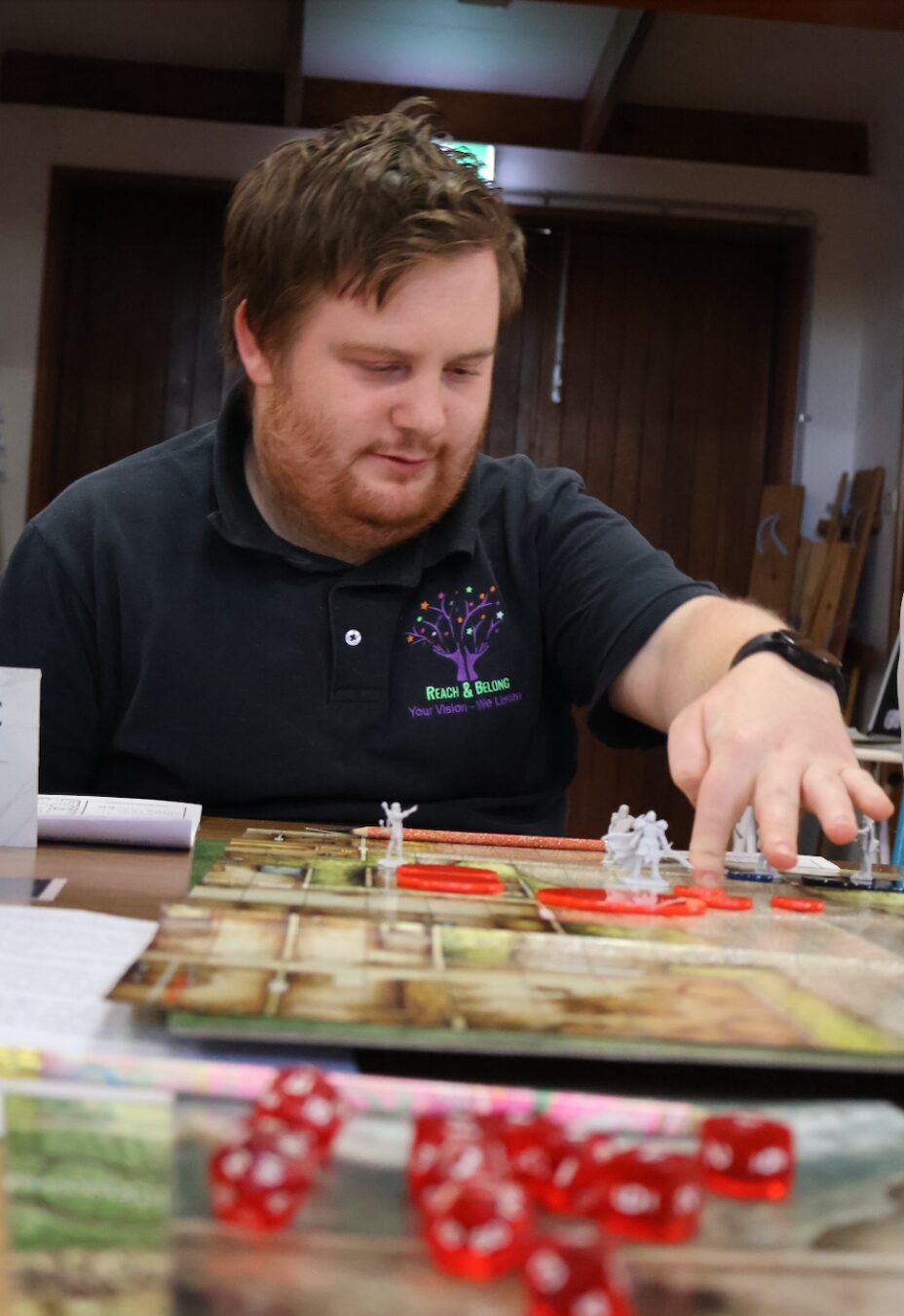 Reach and Belong NDIS participant playing Dungeons and Dragons in one of their social groups